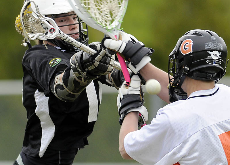 IT’S GOOD: Maranacook/Winthrop’s Zach Glazier, left, shoots a goal past Gardiner Area High School goalie JD Corcker on Wednesday in Gardiner.
