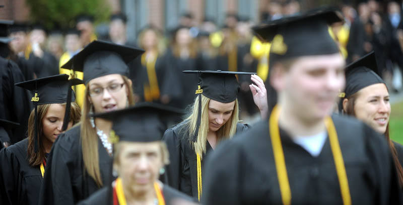 Thomas College's class of 2013 march in to the Harold Alfond Athletic Center for the 119th commencement ceremony in Waterville on Saturday.
