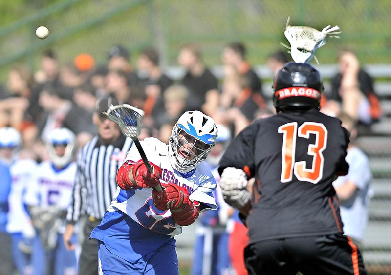 TAKE THE SHOT: Messalonskee High School’s Ryan Erskine, left, takes a shot on goal as Brunswick High School’s Ezra Rogers (13) plays defense in the first quarter of their game Friday at Messalonskee High School in Oakland.
