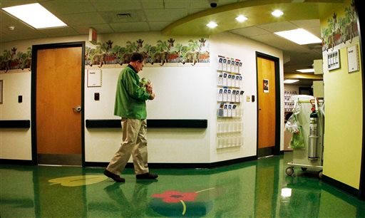 Bob Woodruff, a volunteer cuddler, walks the hallway with a baby at East Tennessee Children's Hospital in Knoxville, Tenn. East Tennessee Children's Hospital