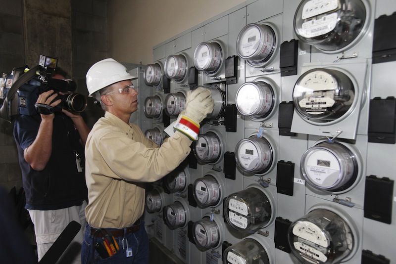 In this September 2010 file photo, Central Maine Power technician Gary Sturgis installs one of the company's first "smart meters" at an apartment building in Portland, Maine. Central Maine Power Co. is asking state regulators to approve a new rate plan that would add roughly $2 a month to the average home bill each year for the next five years. (AP Photo/Joel Page)