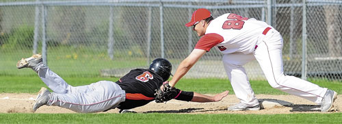 YOU’RE OUT: Skowhegan’s Kaleb Brown, left, can’t beat the pick-off throw back to first base in time and gets tagged out by Cony’s Ben Lucas on Friday in Augusta.