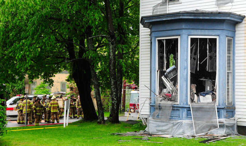Firefighters from several departments work at corner of at 26 Pleasant St. in Augusta on Sunday. John Murray, 62, of Augusta, who was injured seriously in that fire, had called the city just two days earlier seeking an inspection to address safety concerns he had about his unit.