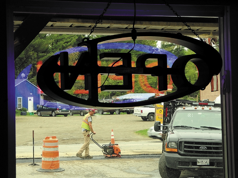 Paving crews work in front of Windsor Convenience covering over a trench where natural gas pipeline was recently laid along Route 17 on Thursday in Windsor.