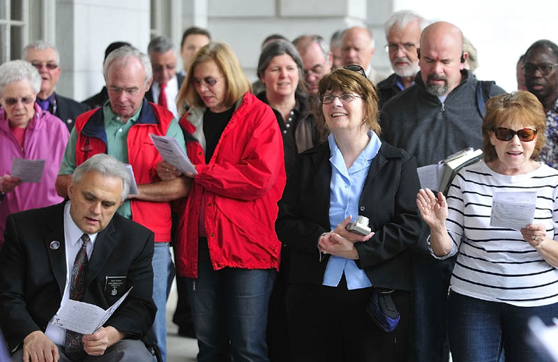 Participants sing "How Great Thou Art" to wrap up the National Day of Prayer event on Thursday on the State House front steps in Augusta. The singing was preceded by the reading of a proclamation by Gov. Paul LePage and the reading aloud of the 2013 Prayer for the Nation. The event also included a prayer walk around the State House and the city of Augusta.