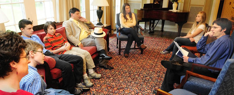 Local author Christopher Osgood, right, of Hallowell, reads one of his short stories to a group of home-school families on Tuesday, in the sun room at Blaine House in Augusta. Osgood, who has performed readings at several area schools, has written 19 stories for children that he plans to get published in book form.