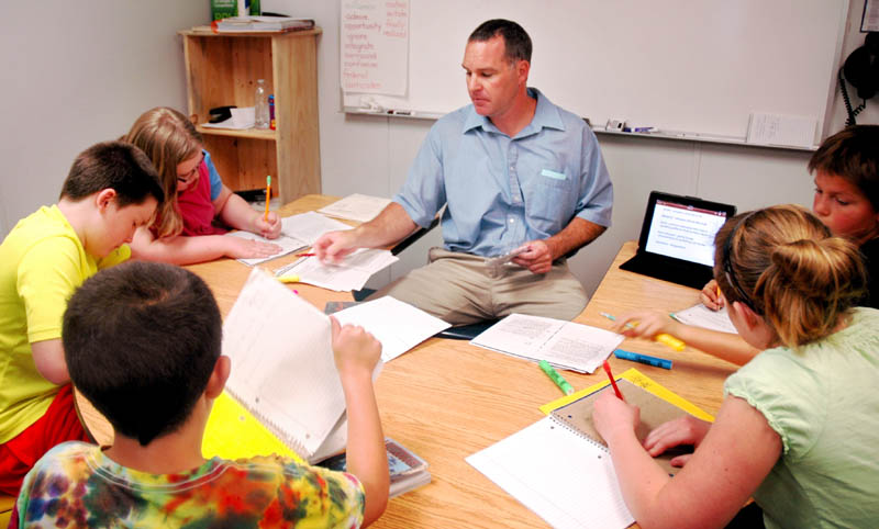 Fifth-grade teacher Michael Louder works in a small group with students at Canaan Elementary School during a reading workshop Friday. The school was one of two in Skowhegan-based School Administrative District 54 that Department of Education Commissioner Stephen Bowen visited that day.
