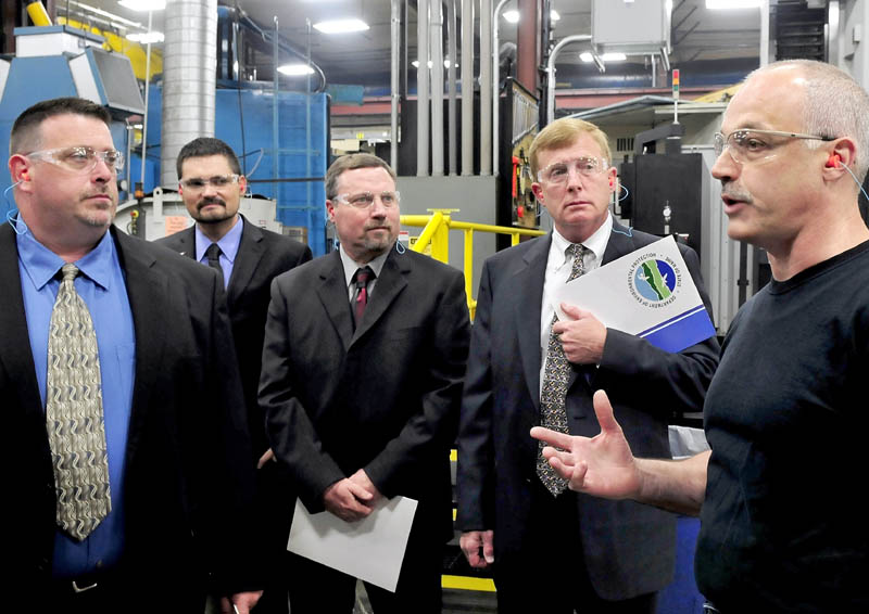 Mid-State Machine employee Steve Meunier, right, leads a tour through the Winslow company on Wednesday for a group with Edwards-United Technologies. The Pittsfield company was one of five businesses to receive a 2013 Environmental Excellence award from the state. From left are Bob Belanger, Steve LaMarre, Vern Palmer and Plant Manager Christopher Smith.