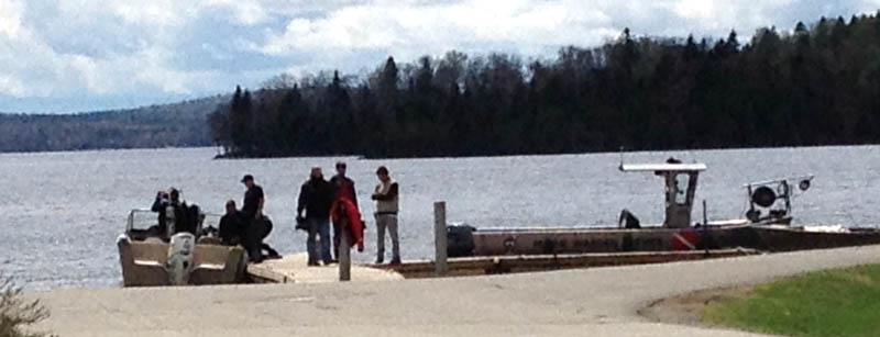 Maine Warden Service divers searched Rangeley Lake Thursday for three snowmobilers missing since winter.