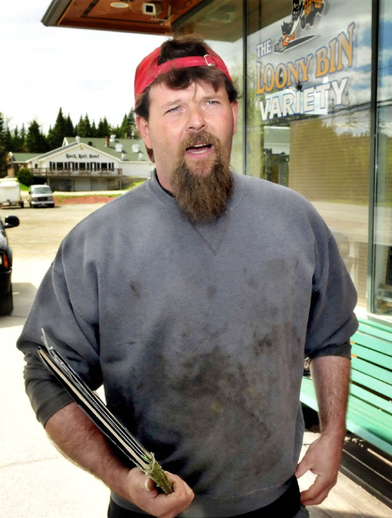 Roger Palmer speaks Tuesday outside the Loony Bin Variety store in Rangeley, about the impact that the deaths of three snowmobilers in December have had on the town.