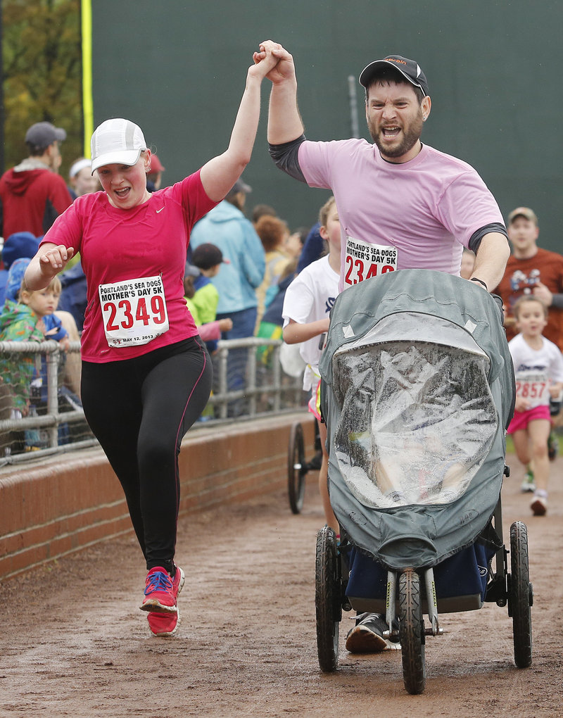 Photos by Derek Davis/Staff Photographer Three-year-old Maxwell Conn probably was saying “Faster, Mommy and Daddy!” to parents Erinn and Jeremy Conn, who did the real legwork.