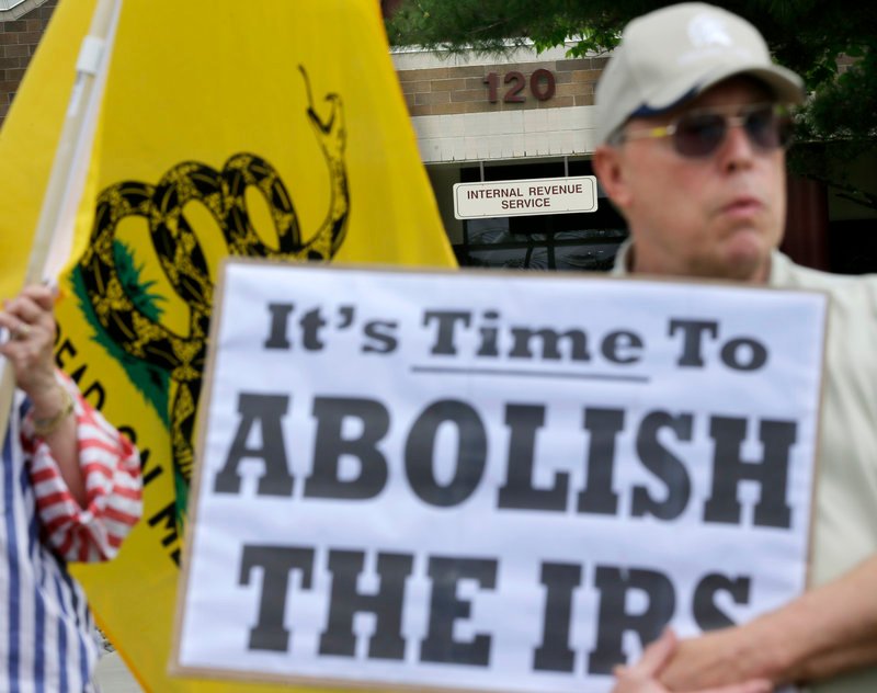 Cliff Toye joins others outside Internal Revenue Service offices in Cherry Hill, N.J., on Tuesday for a tea party rally protesting extra IRS scrutiny of conservative groups.