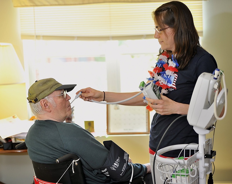 Nikki Rollins, a certified nurse assistant, takes the temperature and blood pressure of a resident at the Mid Coast Senior Health Center in Brunswick last month. The House has passed some changes to the 2011 health-care reform law, but by slim margins that wouldn't stand up to a veto by the governor.