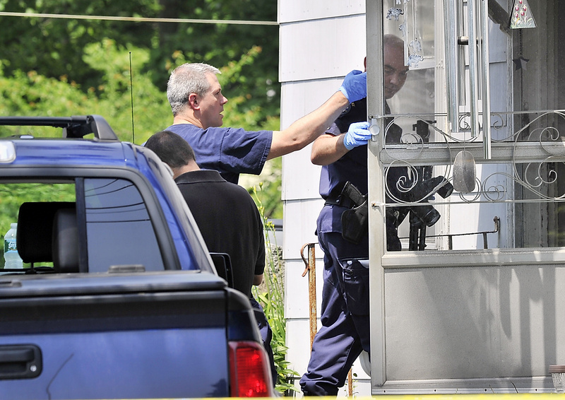 Maine State Police evidence technicians enter the home on Route 136 in Freeport where a father and son were found dead Tuesday.
