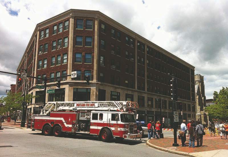 A one-block section of High Street between Congress and Deering streets will remain closed until at least noon Monday after the brick facade on the Congress Building, shown here, began to bow out and separate from the wall.