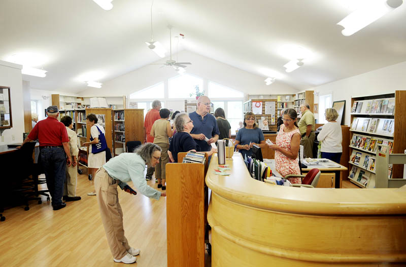 Patrons crowd the Belgrade Public Library Sunday during the official opening ceremony.
