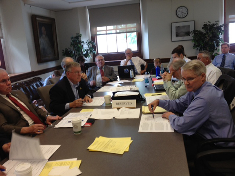 Sen. Pat Flood, R-Winthrop, foreground, right, discusses the proposed state budget with fellow Republican senators Wednesday before the vote on a possible override of Gov. Paul LePage’s budget veto.