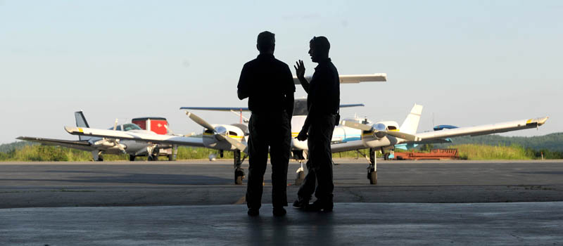 Bruce Olson, owner of Tree Spirits and a Mid-Maine Chamber of Commerce member, speaks with Robert LaFleur Municipal Airport manager Randy Marshall Jr. at the newly renovated airport in Waterville, for a Business After Hours event on Wednesday.