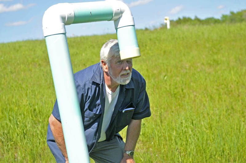 Johnny Thomas inspects a methane vent pipe on top of the dump at the Oakland transfer station on Wednesday.