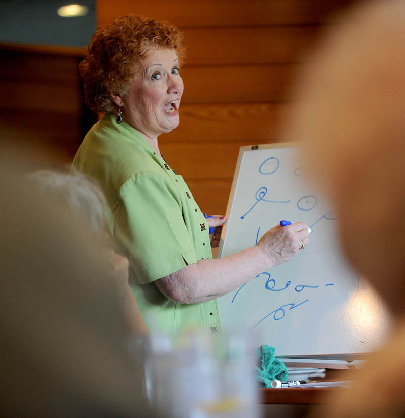 Kay Grindall teaches the finer points of shorthand to the Shorthand Writers of Maine during lunch at the Weathervane Restaurant on Kennedy Memorial Drive in Waterville on Friday.