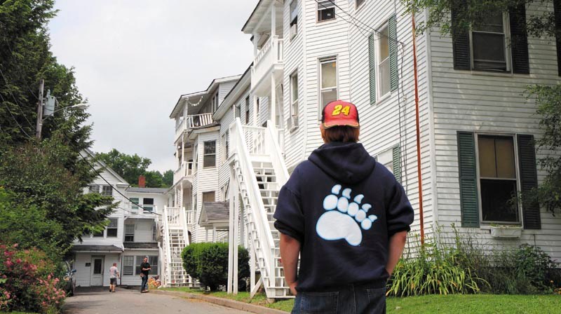 Tenant Josh Harrison wait for the OK to re-enter his 26 Sewall St., Augusta, apartment building on Sunday. A fire in an upstairs unit Saturday night caused the evacuation of the residents of the 17-unit building. No one was hurt in the fire.