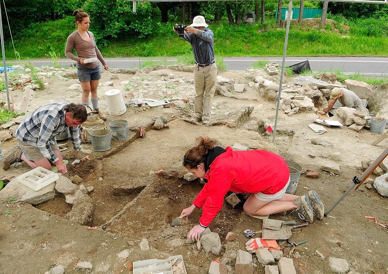 Leith Smith, chief archeologist with the Maine Historic Preservation Commission, photographs a section of the archeological dig on Tuesday at the Fort RIchmond site, near the Kennebec River in RIchmond.