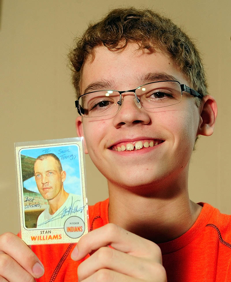 SIGN HERE PLEASE: Sean Tenney holds up a baseball card signed by Stan Williams. Tenney sent letters to a number of old-time baseball players, asking them questions about their careers and got a number of responses.