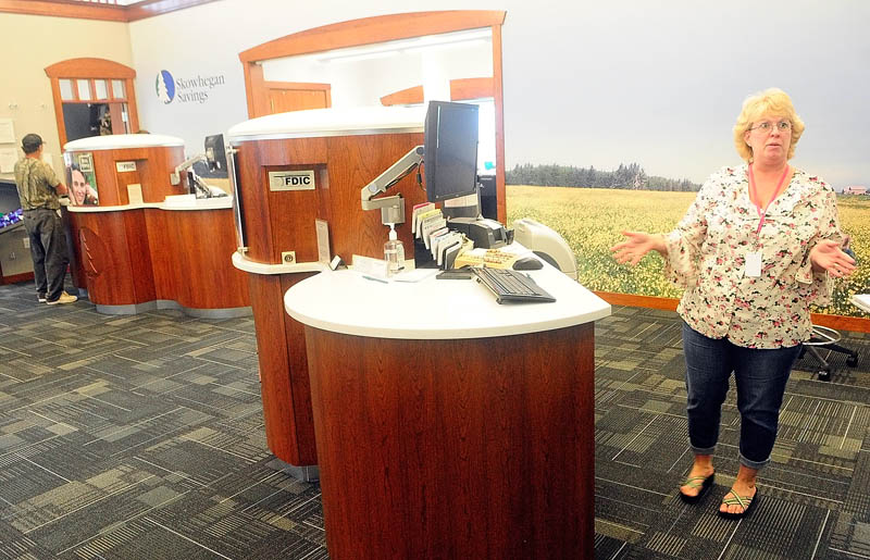 Branch supervisor Tina Trahan talks about the new dialog banking system on Friday at the Skowhegan Saving branch on Route 27 in Augusta.
