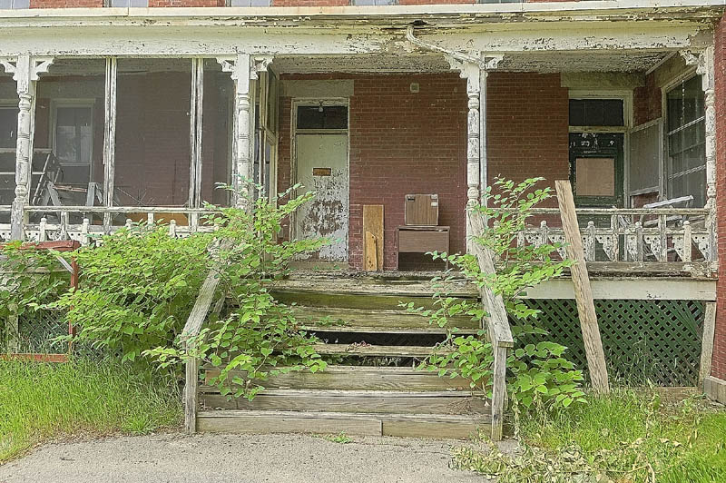 The porch of a building in the Stevens School complex shows signs of wear and disrepair on Friday in Hallowell.