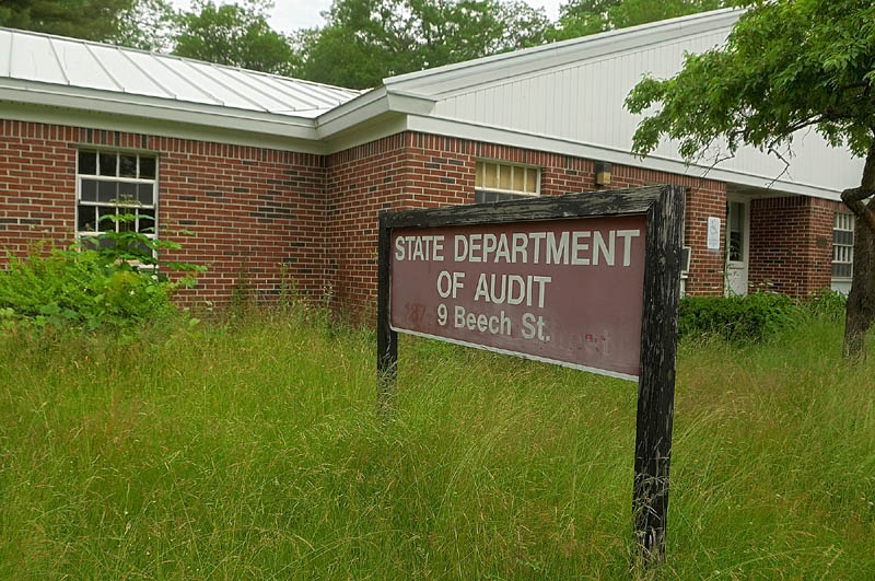 Tall grass grows around the former Department of Audit office, in the Stevens School complex, on Friday in Hallowell.