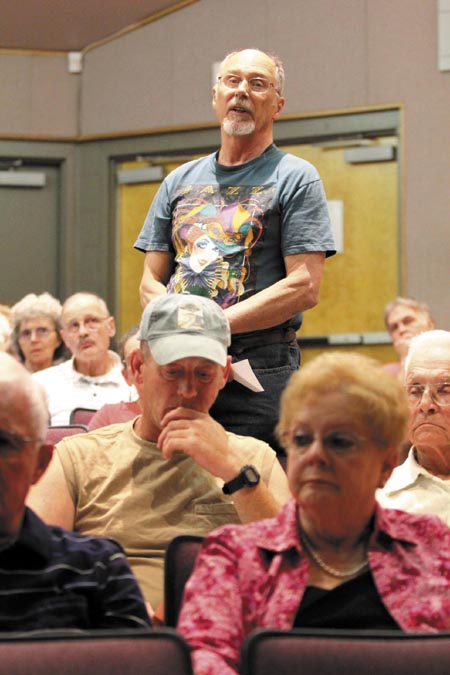 Peter Swartz addresses the Farmingdale Board of Selectmen regarding Article 10 at the annual Town Meeting, at Hall-Dale Middle School on Saturday. The article, which was rejected by residents, was a proposal for the town to spend up to $85,000, plus survey and closing costs, for a 3.67-acre parcel with a sand and salt containment area and covered salt storage structure.