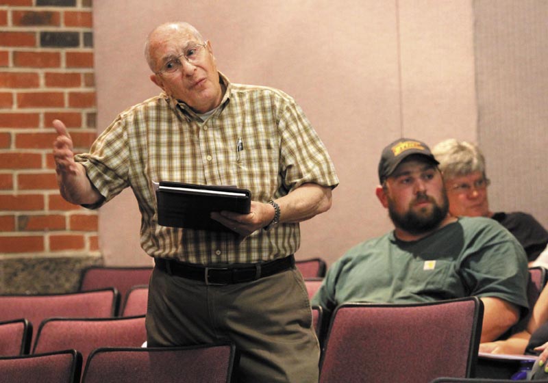Gene Moreau answers a question about Article 10 at the Farmingdale Town Meeting, at Hall-Dale Middle School, on Saturday.