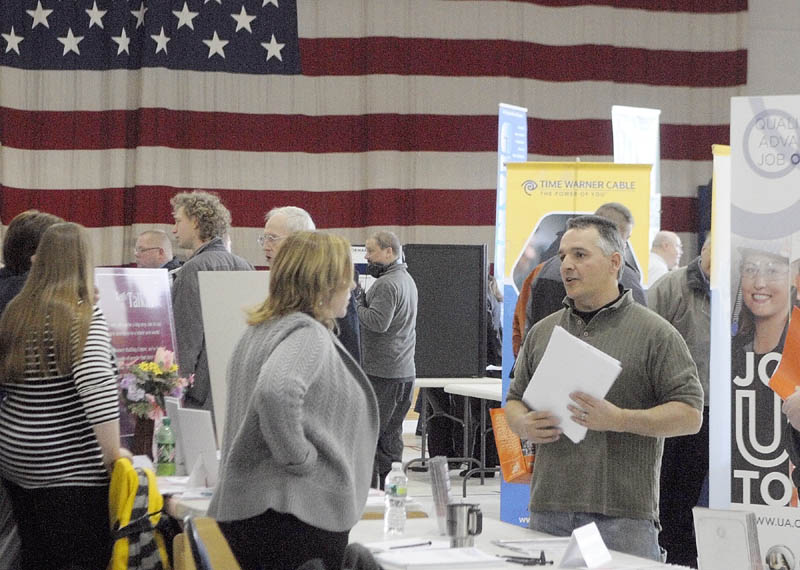 Staff photo by Joe Phelan Stacey L. Morrison, chief executive officer of Ganneston Construction Corp., center left, chats with Jeff Dube, of Rome, during a job fair on Wednesday March 20, 2013 in the Augusta Armory. �Hiring Maine�s Heroes Job Fair� tomorrow, March 20th, at the Augusta Armory. It will feature special programs and information about employment opportunities. The job fair will take place from 10:00 a.m. to 3:00 p.m. at the Augusta Armory, 179 Western Avenue. The event is co-sponsored by the Employer Support of the Guard and Reserve (ESGR) and the Augusta CareerCenter. (Standalone)