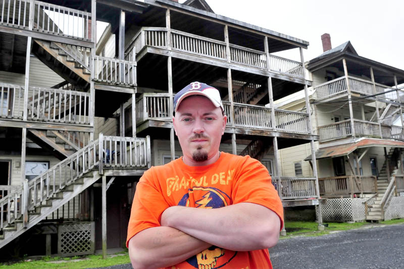 Bobbi Frappier stands outside the Waterville apartment building known as the "Beehive" on Wednesday. Frappier was 12-years-old when he found his grandmother Martha Daigle who had been murdered in the building in 1989. Alan Powell was convicted for the murder and died at the Maine State Prison Tuesday after an altercation with convicted murderer Guy Hunnewell lll.