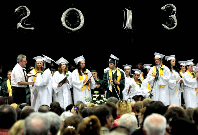 School Administrative District 74 Superintendent Ken Coville confers a diploma to Carrabec High School graduate Samantha Gray during commencement in North Anson on Sunday.