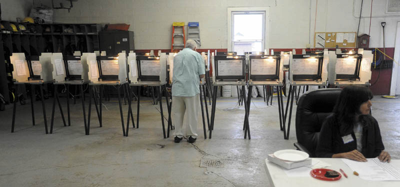 A voter casts a ballot in the school budget validation referendum vote at the Madison Fire Department on Thursday.