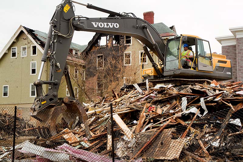 A demolition crew cleans up the rubble from a Blake Street fire in Lewiston on Thursday. Lewiston police charged a 12-year-old boy with setting the fire, who has since turned 13.