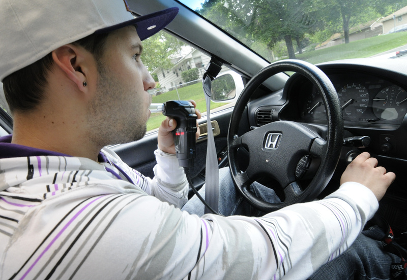 Zachary Glaros, who has three drunken-driving convictions on his record, demonstrates the interlock ignition system that requires him to blow into a tube to prove he is sober before starting his car, at his Bloomington, Minn., home. A new Maine law allows people convicted of drunken-driving to shorten their license suspensions if they use such a device.