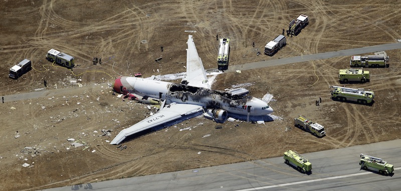 In this Saturday, July 6, 2013 aerial photo, the wreckage of Asiana Flight 214 lies on the ground after it crashed at the San Francisco International Airport, in San Francisco. The pilot at the controls of airliner had just 43 hours of flight time in the Boeing 777 and was landing one for the first time at San Francisco International. (AP Photo/Marcio Jose Sanchez)