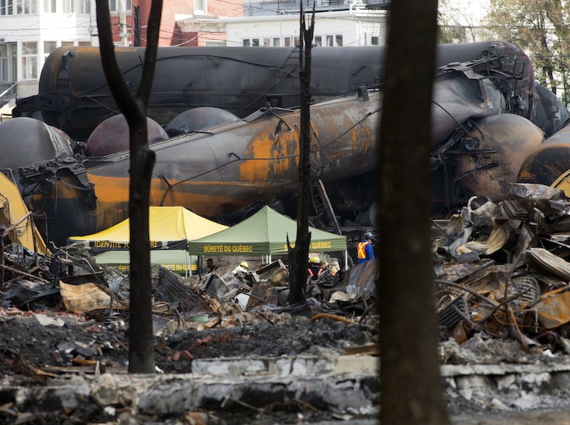 Wrecked tanker cars are pictured during cleanup on Tuesday, July 16, 2013, at the crash site of the train derailment and fire in Lac-Megantic, Quebec. The derailment July 6, 2013, left 37 people confirmed dead and another 13 missing and presumed dead. (AP Photo/The Canadian Press, Ryan Remiorz)