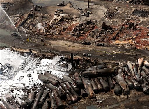 The downtown core lays in ruins as fire fighters continue to water smoldering rubble Sunday in Lac-Mégantic, Quebec. Franklin County Emergency Management Director Tim Hardy and Phillips firefighter Josh Bachelder called the Saturday train derailment and fire in Lac-Mégantic, Quebec, a horrific scene of destruction.