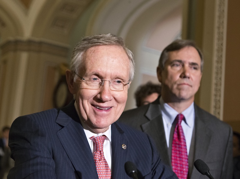 Senate Majority Leader Harry Reid, D-Nev., joined by Sen. Jeff Merkley, D-Ore., right, speak to reporters after the Senate stepped back from the brink of a political meltdown, clearing the way for confirmation of one of President Barack Obama’s long-stalled nominations, at the Capitol in Washington, Tuesday, July 16, 2013. (AP Photo/J. Scott Applewhite)