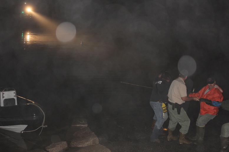 A crew works to recover the vehicle in which two women died after accidentally driving into Englishman's Bay.