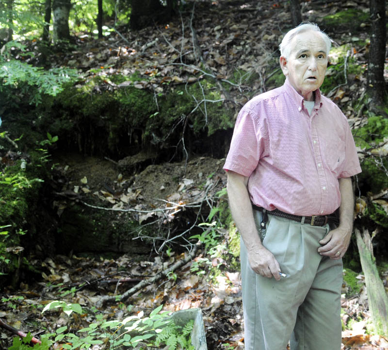 Garrett Hollands said a shelter, at left, in Rome was discovered in the late 1980s. A wood-frame bunker excavated into the side of a hill contained books, a bed frame, cooking material and propane tanks, behind a sliding-glass window entrance, according to Hollands. Remnants of glass and metal were still apparent when Holland led his family to the site on July 3.