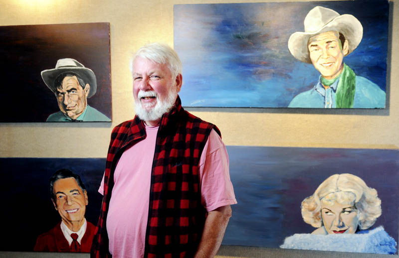 University of Maine at Augusta professor J. Powers "Kid" McGuire stands near some work in his show at the Danforth Gallery on Wednesday. The four paintings, titled "Rogers-o-rama," depict Roy Rogers, top right, Ginger Rogers, Will Rogers, top left, and Fred Rogers.