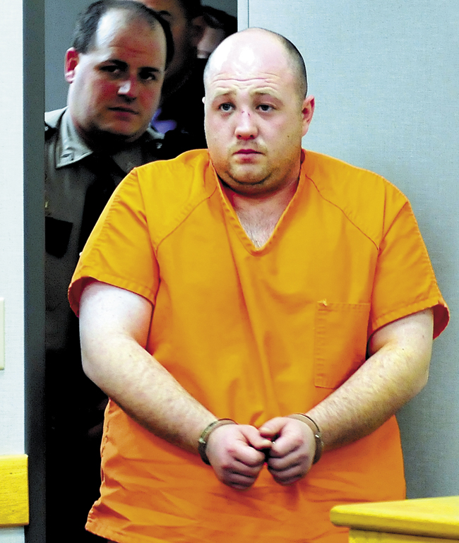 Matthew Partridge of Winslow is led into District Court in Waterville on Dec. 5, 2012, for an initial appearance in the shooting death of Justin Smith of China Tate.
