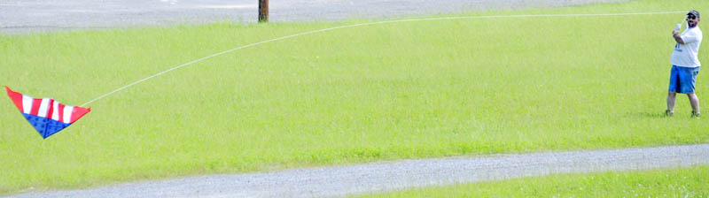 Dan Mayle attempts to right his kite Sunday while flying at Mill Park in Augusta. Mayle and his friend, Patricia Anderson, both of Gardiner, tried to float two kites that refused to stay airborne. "The breeze isn't working," Mayle said.