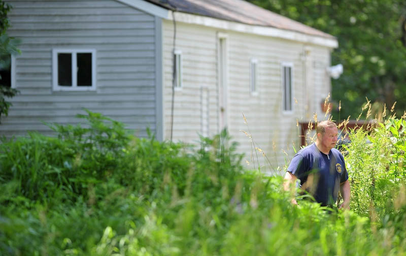 Maine State Police search the residence at 24 Main St in Detroit on Friday where a man was found dead Thursday morning.