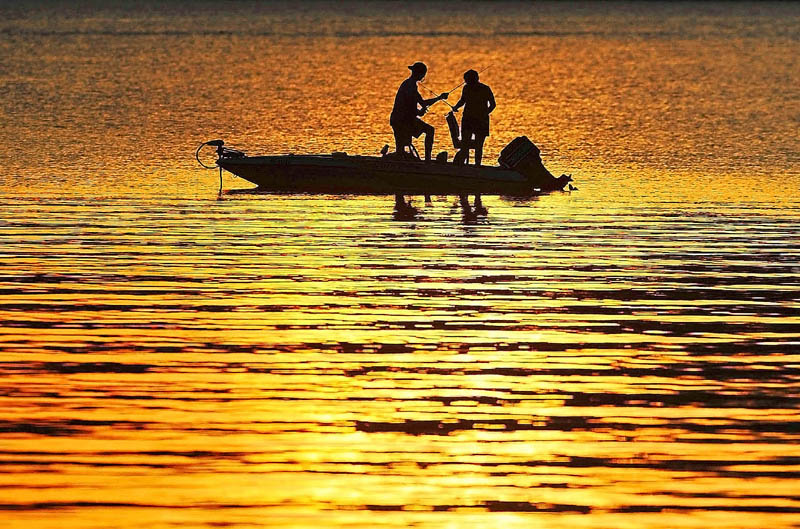 Fisherman cast their lines on to a sun drenched Great Pond in Belgrade on Sunday. The pond was made famous by Ernest Thompson's screenplay, "On Golden Pond."