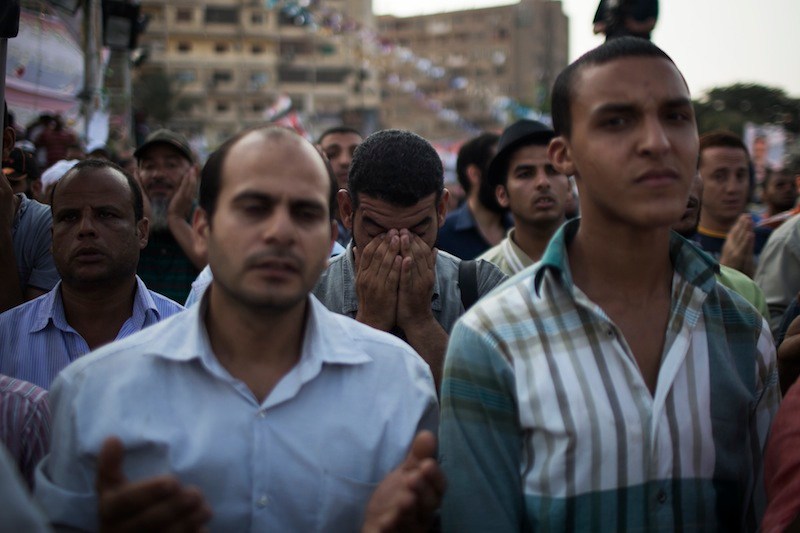 Supporters of the ousted Egypt's President Mohammed Morsi pray during a protest in Nasr City, a suburb of Cairo, Egypt, Tuesday July 9, 2013. After days of deadlock, Egypt's military-backed interim president named a veteran economist as prime minister on Tuesday and appointed pro-democracy leader Mohamed ElBaradei as a vice president, while the army showed its strong hand in shepherding the process, warning political factions against “maneuvering” that impedes the transition. (AP Photo/Manu Brabo)
